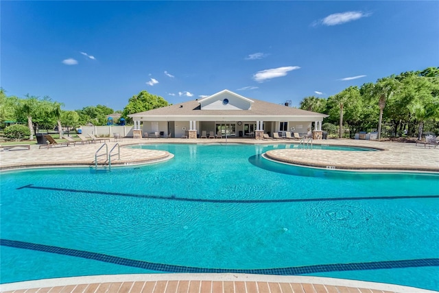 community pool featuring a patio area and fence