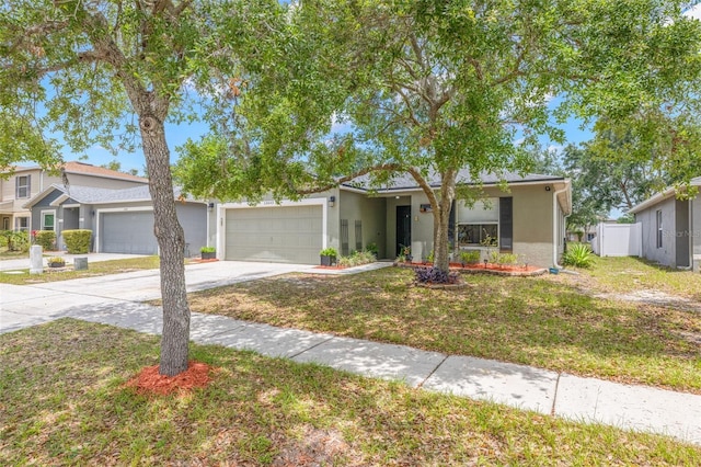 13643 Tramore Dr, Odessa, FL 33556 - view of front of house featuring driveway, a garage, stucco siding, and a front yard