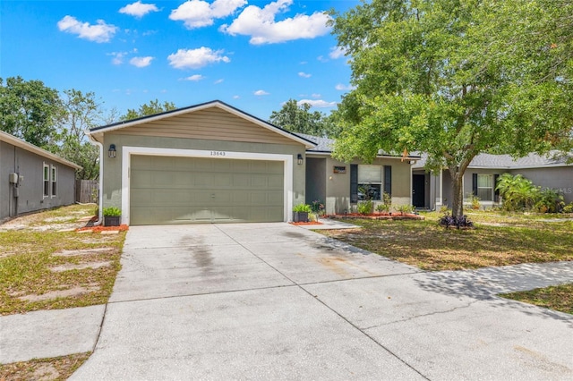 13643 Tramore Dr, Odessa, FL 33556 - ranch-style home featuring an attached garage, stucco siding, and driveway