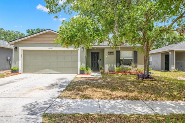 13643 Tramore Dr, Odessa, FL 33556 - single story home featuring an attached garage, stucco siding, and driveway