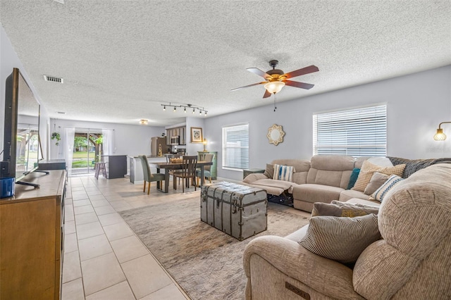 13643 Tramore Dr, Odessa, FL 33556 - living room with a ceiling fan, light tile patterned floors, plenty of natural light, a textured ceiling, and rail lighting