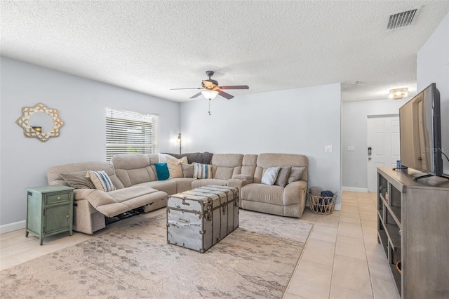 13643 Tramore Dr, Odessa, FL 33556 - living area featuring a ceiling fan, light tile patterned floors, a textured ceiling, and baseboards
