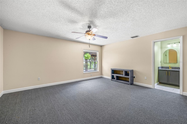 13643 Tramore Dr, Odessa, FL 33556 - unfurnished living room with ceiling fan, carpet, a sink, a textured ceiling, and baseboards