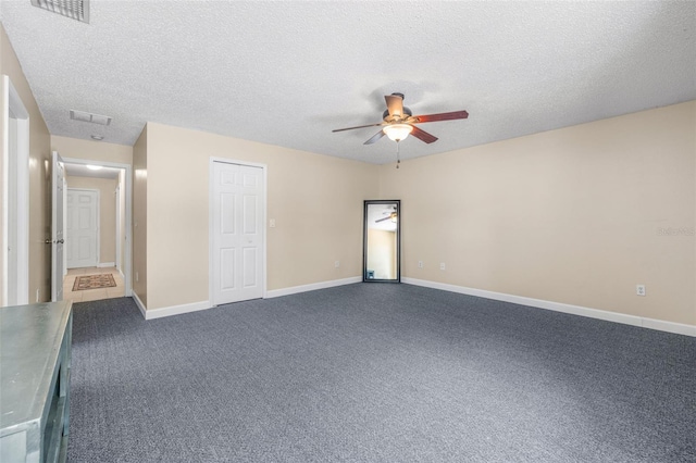 13643 Tramore Dr, Odessa, FL 33556 - unfurnished bedroom with dark colored carpet, baseboards, a textured ceiling, and ceiling fan