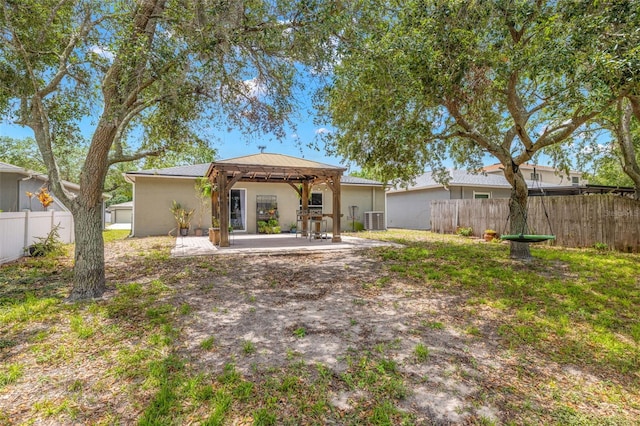 13643 Tramore Dr, Odessa, FL 33556 - rear view of property with a gazebo, central air condition unit, a patio area, stucco siding, and fence