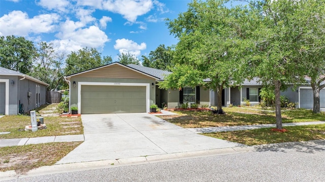 13643 Tramore Dr, Odessa, FL 33556 - view of front of property featuring a garage, concrete driveway, and stucco siding
