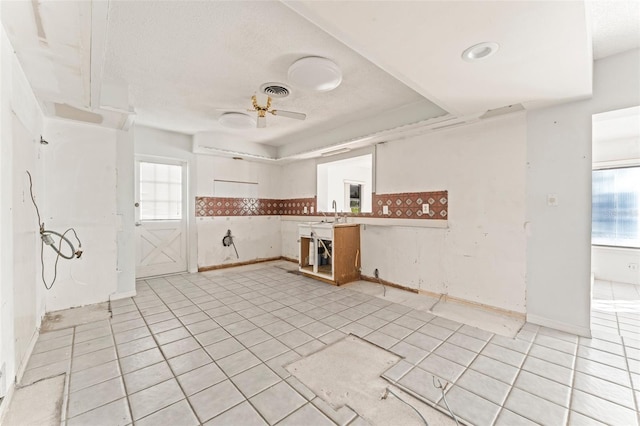 5 Marina Ter, Treasure Island, FL 33706 - kitchen with a ceiling fan, light tile patterned floors, a textured ceiling, a sink, and baseboards