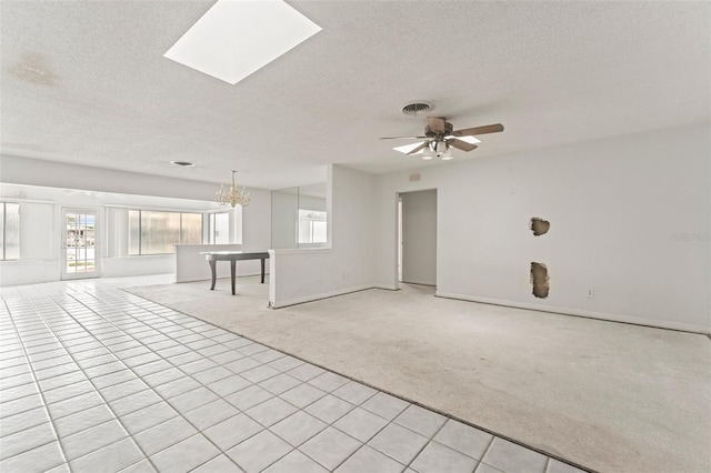 5 Marina Ter, Treasure Island, FL 33706 - spare room with light carpet, a textured ceiling, a ceiling fan, baseboards, and light tile patterned floors