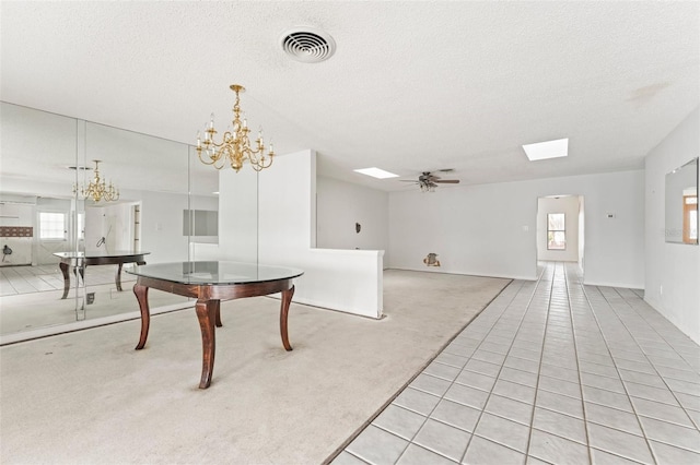 5 Marina Ter, Treasure Island, FL 33706 - dining room featuring a chandelier, light carpet, ceiling fan, a textured ceiling, and a skylight