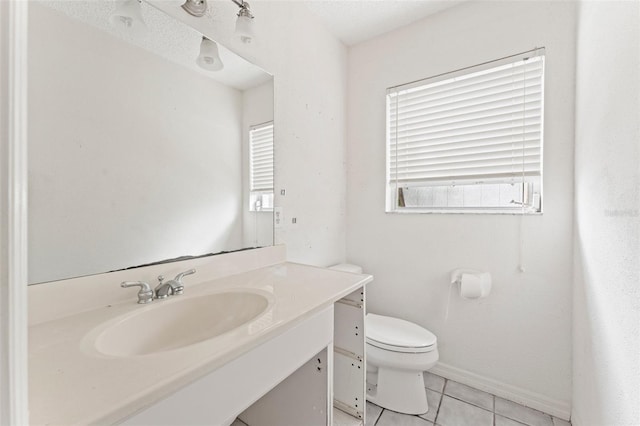 5 Marina Ter, Treasure Island, FL 33706 - bathroom featuring toilet, vanity, tile patterned floors, and baseboards
