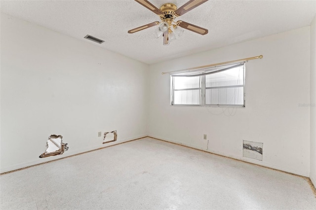 5 Marina Ter, Treasure Island, FL 33706 - spare room with a textured ceiling, ceiling fan, and baseboards