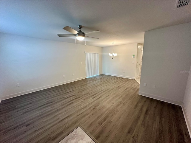 1253 Dosseywood Ln, Lakeland, FL 33811 - spare room featuring a chandelier, ceiling fan, dark wood finished floors, and baseboards