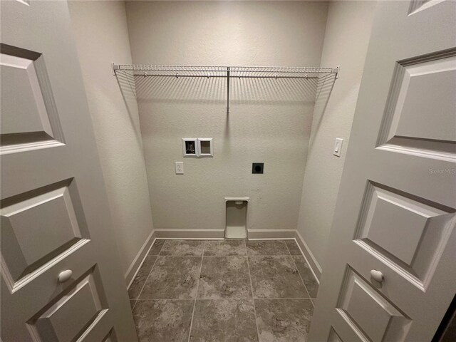 1253 Dosseywood Ln, Lakeland, FL 33811 - clothes washing area with electric dryer hookup, baseboards, hookup for a washing machine, and dark tile patterned floors
