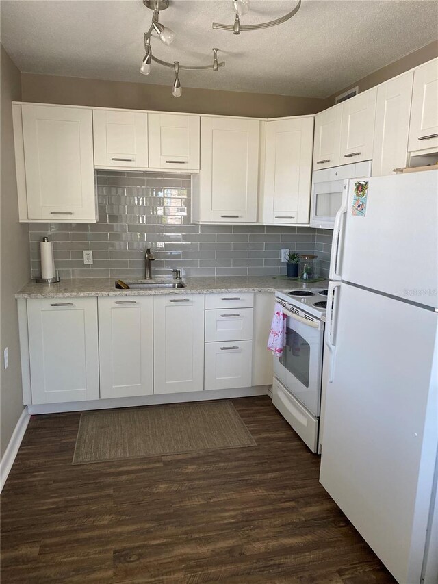 8455 112th St Unit 212, Seminole, FL 33772 - kitchen featuring white appliances, a sink, white cabinetry, and dark wood-style flooring