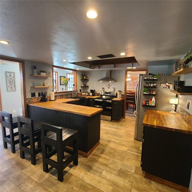 314 Bloomingfield Dr, Brandon, FL 33511 - kitchen with wooden counters, stainless steel appliances, open shelves, a peninsula, and a textured ceiling