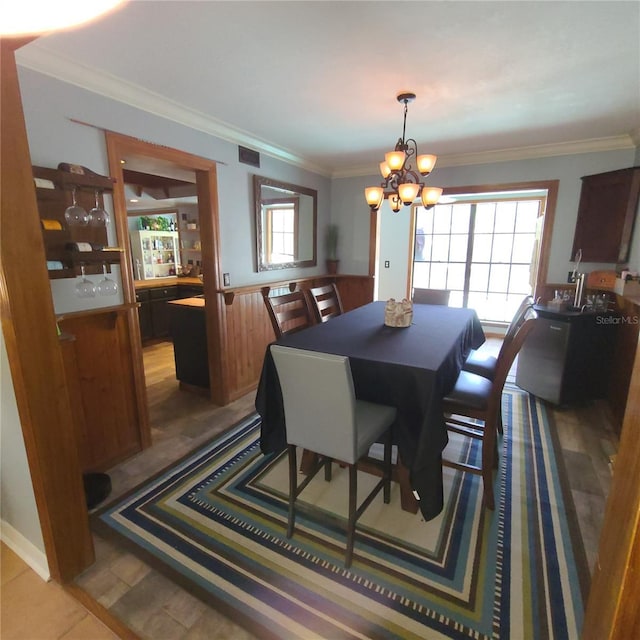 314 Bloomingfield Dr, Brandon, FL 33511 - dining area featuring a chandelier, ornamental molding, and wainscoting