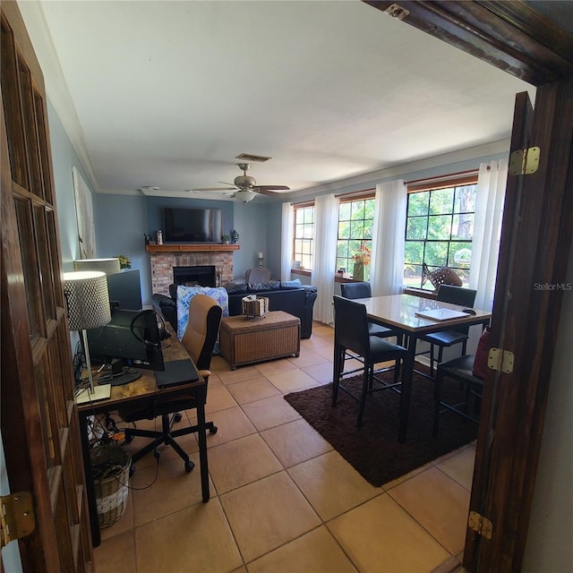 314 Bloomingfield Dr, Brandon, FL 33511 - dining area with light tile patterned floors, a brick fireplace, and a ceiling fan