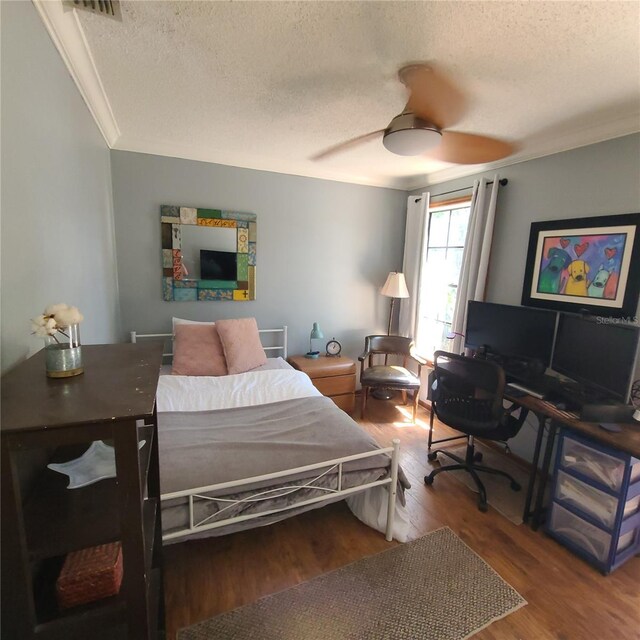 314 Bloomingfield Dr, Brandon, FL 33511 - bedroom with a textured ceiling, wood finished floors, crown molding, ceiling fan, and a desk