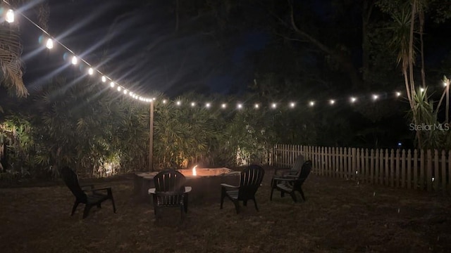 314 Bloomingfield Dr, Brandon, FL 33511 - patio at night with an outdoor fire pit and fence