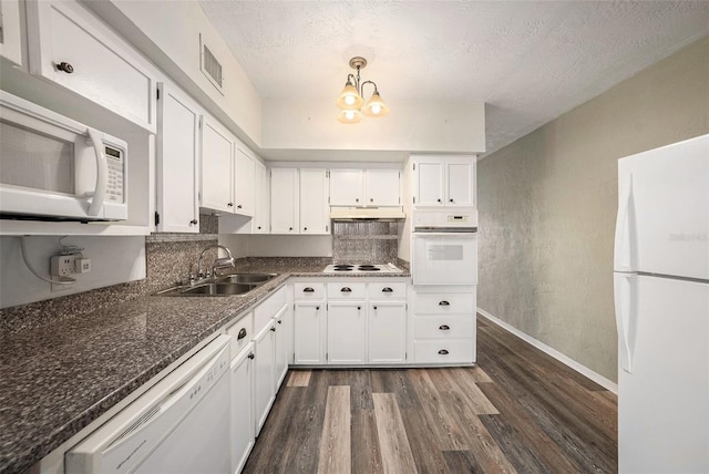 2002 Australia Way E Unit 66, Clearwater, FL 33763 - kitchen with white appliances, a sink, dark wood-type flooring, a textured ceiling, and white cabinetry