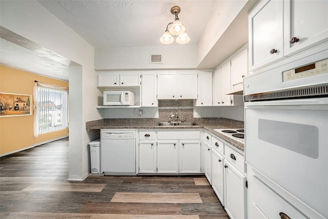 2002 Australia Way E Unit 66, Clearwater, FL 33763 - kitchen with white appliances, a sink, white cabinetry, dark wood-style floors, and a textured ceiling