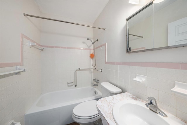 2002 Australia Way E Unit 66, Clearwater, FL 33763 - bathroom with tile walls, a sink, toilet, shower / bath combination, and a wainscoted wall