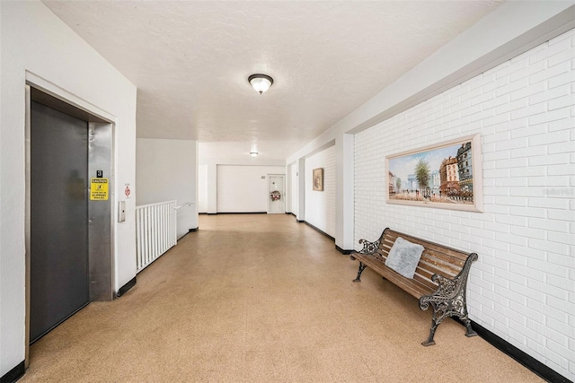 2002 Australia Way E Unit 66, Clearwater, FL 33763 - hall featuring tile patterned floors, elevator, brick wall, and baseboards