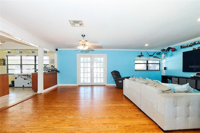 9802 N Oregon Ave, Tampa, FL 33612 - living area featuring a ceiling fan, light wood-style flooring, crown molding, healthy amount of natural light, and recessed lighting
