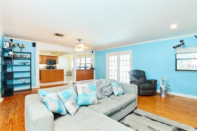 9802 N Oregon Ave, Tampa, FL 33612 - living area featuring crown molding, light wood-type flooring, ceiling fan, and baseboards