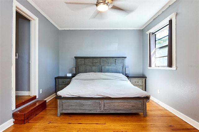 9802 N Oregon Ave, Tampa, FL 33612 - bedroom featuring ornamental molding, light wood-type flooring, baseboards, and ceiling fan
