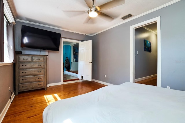 9802 N Oregon Ave, Tampa, FL 33612 - bedroom with wood finished floors, crown molding, baseboards, and a ceiling fan