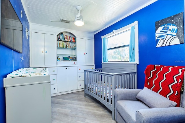 9802 N Oregon Ave, Tampa, FL 33612 - bedroom with wood finished floors, ornamental molding, and a ceiling fan