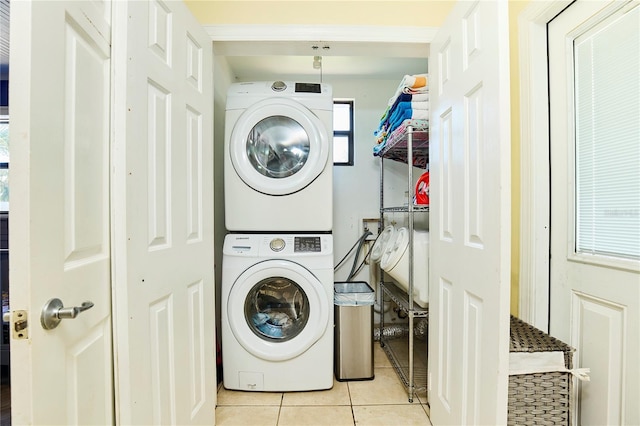9802 N Oregon Ave, Tampa, FL 33612 - washroom featuring estacked washer and dryer and light tile patterned floors