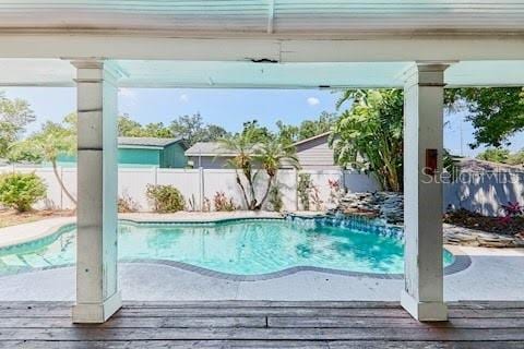 9802 N Oregon Ave, Tampa, FL 33612 - view of pool featuring a fenced backyard and a wooden deck