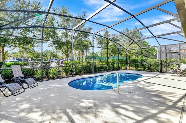 5247 Wildwood Way, Davenport, FL 33837 - outdoor pool featuring a patio area and a lanai