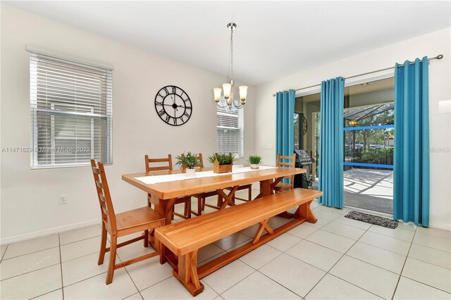 5247 Wildwood Way, Davenport, FL 33837 - dining space with a chandelier, light tile patterned floors, and baseboards