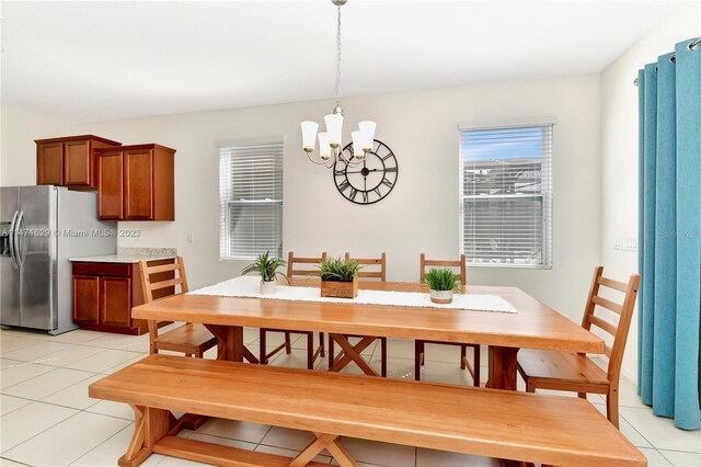 5247 Wildwood Way, Davenport, FL 33837 - dining space featuring a chandelier and light tile patterned floors