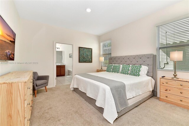 5247 Wildwood Way, Davenport, FL 33837 - bedroom featuring light carpet, connected bathroom, and baseboards