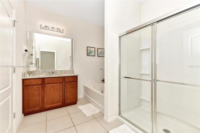 5247 Wildwood Way, Davenport, FL 33837 - bathroom featuring tile patterned floors, a stall shower, a bath, and vanity