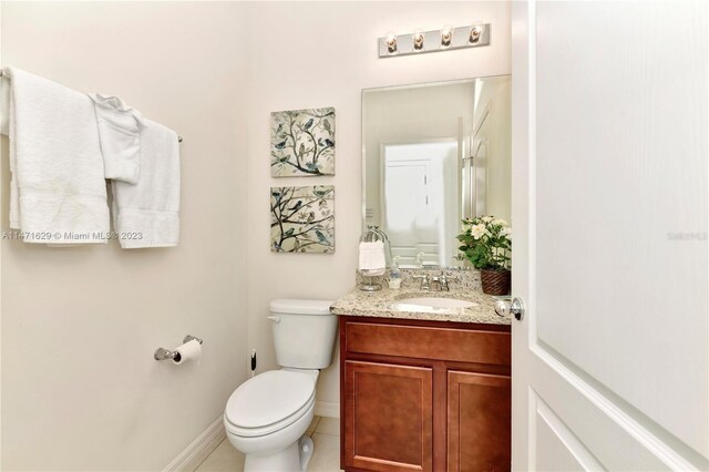5247 Wildwood Way, Davenport, FL 33837 - half bath featuring vanity, toilet, baseboards, and tile patterned flooring