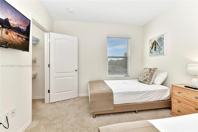 5247 Wildwood Way, Davenport, FL 33837 - bedroom featuring light carpet and baseboards