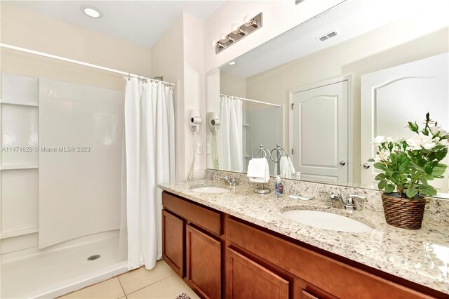 5247 Wildwood Way, Davenport, FL 33837 - bathroom featuring a shower with shower curtain, tile patterned floors, and double vanity
