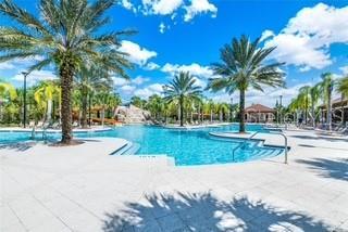 5247 Wildwood Way, Davenport, FL 33837 - community pool featuring a patio area