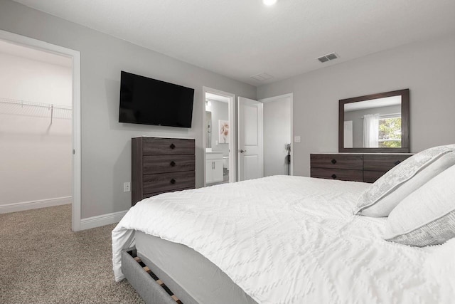 5270 Neil Dr, Saint Petersburg, FL 33714 - bedroom with a spacious closet, baseboards, carpet floors, a closet, and ensuite bathroom