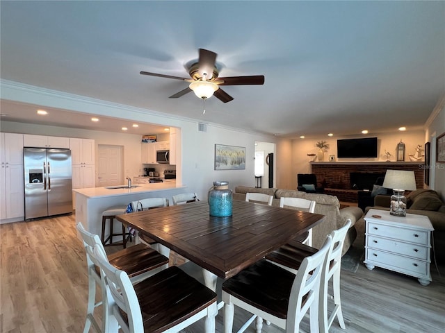 474 20th Ave, Indian Rocks Beach, FL 33785 - dining area with a ceiling fan, light wood-style floors, recessed lighting, and crown molding