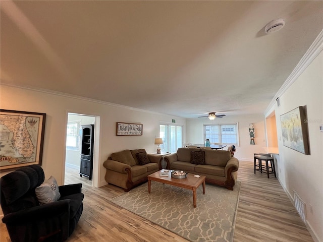 474 20th Ave, Indian Rocks Beach, FL 33785 - living room featuring crown molding, light wood-style flooring, baseboards, and ceiling fan