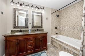 474 20th Ave, Indian Rocks Beach, FL 33785 - full bathroom with double vanity, tiled shower / bath combo, and toilet
