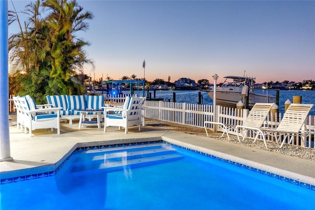 474 20th Ave, Indian Rocks Beach, FL 33785 - pool at dusk featuring a water view, a patio, and an outdoor pool