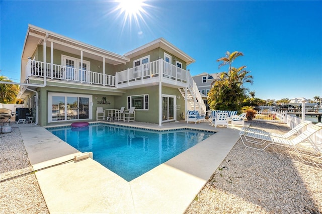 474 20th Ave, Indian Rocks Beach, FL 33785 - rear view of property with a balcony, a patio, an outdoor pool, and stucco siding