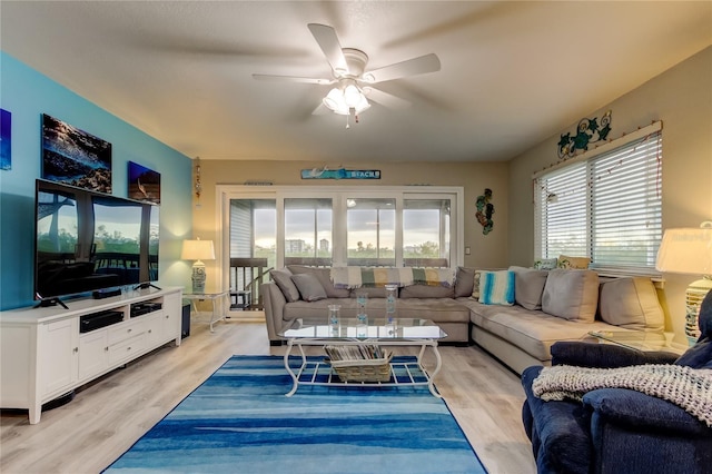 9484 Tara Cay Ct Unit 8, Seminole, FL 33776 - living room with a ceiling fan and light wood-style flooring
